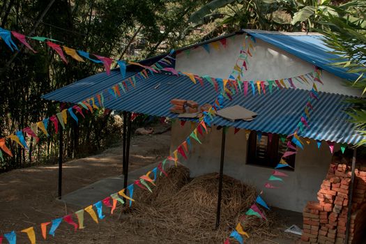 Buddhist praying flags attatched to a small house in a nepalese village, annapurna circuit