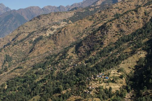 View over huts and terraced rice fields at Annapurna circuit in Nepal