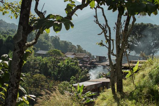 Smoke rising from a beautiful mountain village on the hillside, Bahundanda, Annapurna circuit, Nepal