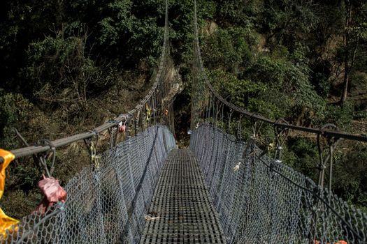 A simple suspension bridge crossing during the Annapurna circuit in Nepal