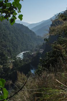 Marshyangdi river flowing through a valley close to a mounatin village at Annapurna circuit, Nepal