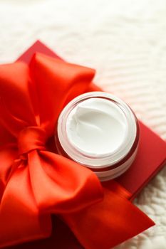 Beauty, cosmetics and skincare styled concept - Luxury face cream jar and red gift box