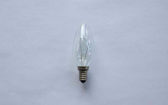 Small tungsten light bulb isolated on white background.