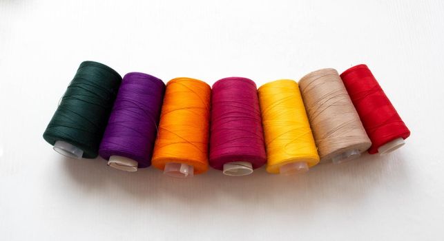 Panorama of colorful bobbins isolated on a white background.
