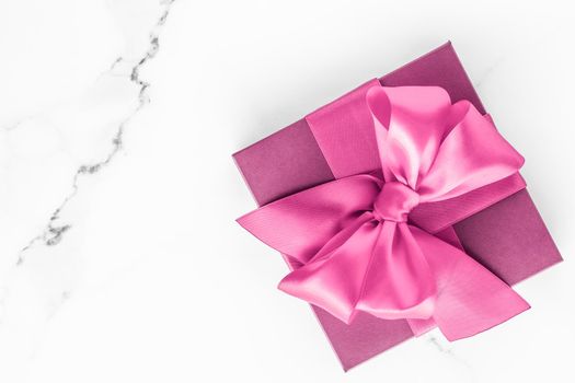 Birthday, wedding and girly branding concept - Pink gift box with silk bow on marble background, girl baby shower present and glamour fashion gift for luxury beauty brand, holiday flatlay art design