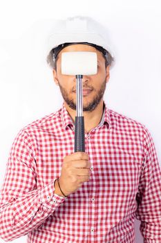 Handsome builder worker with white helmet showing his hammet