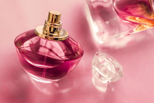 Perfumery, spa and branding concept - Pink perfume bottle on glossy background, sweet floral scent, glamour fragrance and eau de parfum as holiday gift and luxury beauty cosmetics brand design