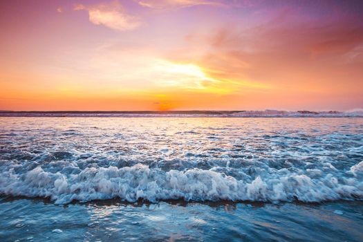 Radiant sunset from Bali Double Six beach surf waves and colorful clouds