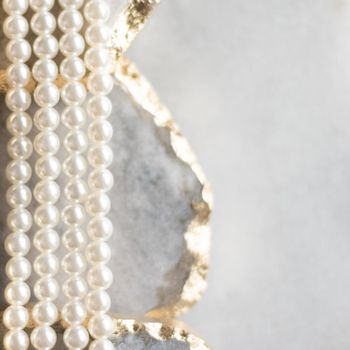 Pearl necklace on golden marble, ethical jewellery - luxury background, jewelry as a gift concept. Pearls are girl's best friends