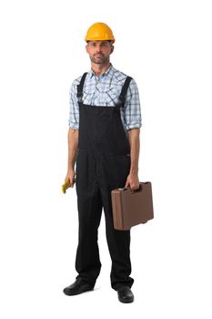 Full length portrait of confident male repairman contractor worker in coveralls holding adjustable spanner and toolbox on white background