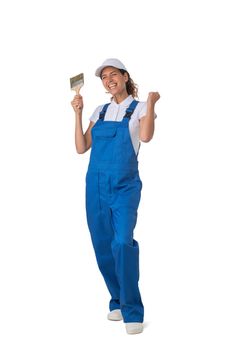 Female house painter with paint brush holding fists isolated on white background full length studio portrait