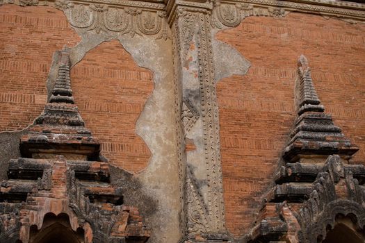 A beautifully decorated brick exterior wall of a historic temple in Bagan, Myanmar