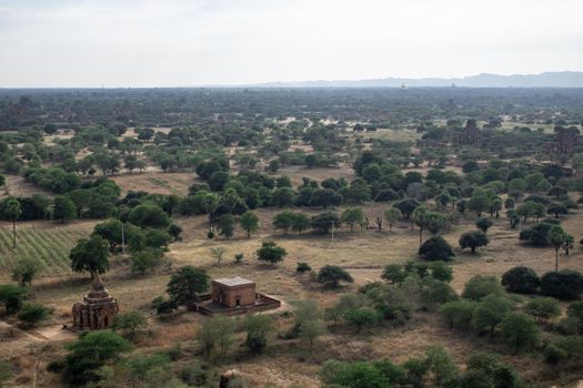 BAGAN, NYAUNG-U, MYANMAR - 3 JANUARY 2020: Looking out over the vast plains of Bagan with its historical temples and fields from the tall Nan Myint viewing tower