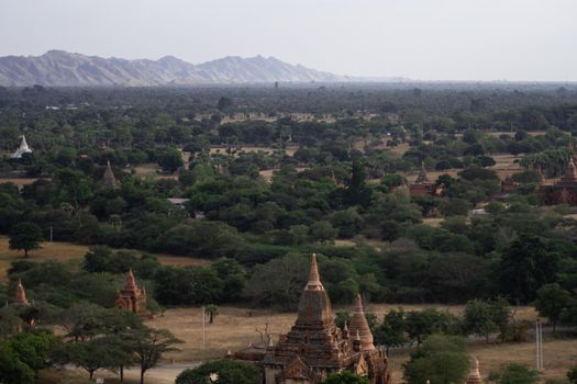 BAGAN, NYAUNG-U, MYANMAR - 3 JANUARY 2020: Looking out over the vast plains of Bagan with its historical temples and fields from the tall Nan Myint viewing tower