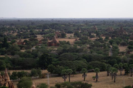 BAGAN, NYAUNG-U, MYANMAR - 3 JANUARY 2020: Looking out over the vast plains of Bagan with its historical temples and fields from the tall Nan Myint viewing tower