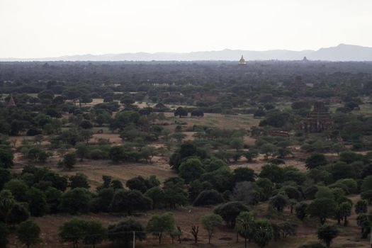 BAGAN, NYAUNG-U, MYANMAR - 3 JANUARY 2020: Looking out over the vast plains of Bagan with its historical temples and fields from the tall Nan Myint viewing tower