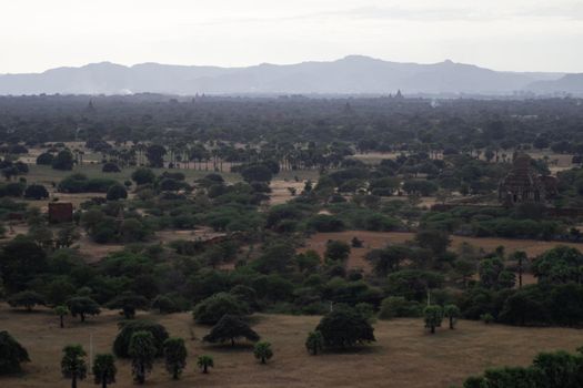 BAGAN, NYAUNG-U, MYANMAR - 3 JANUARY 2020: Looking out over the vast plains of Bagan with its historical temples and fields from the tall Nan Myint viewing tower