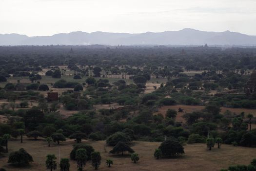 BAGAN, NYAUNG-U, MYANMAR - 3 JANUARY 2020: Looking out over the vast plains of Bagan with its historical temples and fields from the tall Nan Myint viewing tower