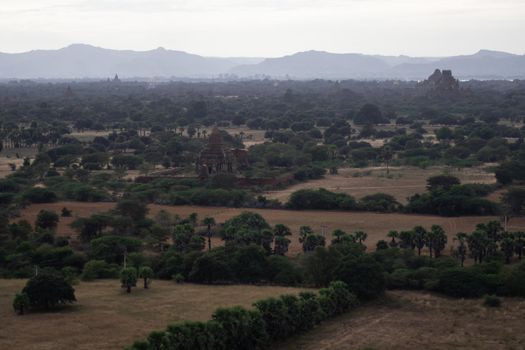 BAGAN, NYAUNG-U, MYANMAR - 3 JANUARY 2020: Looking out over the vast plains of Bagan with its historical temples and fields from the tall Nan Myint viewing tower