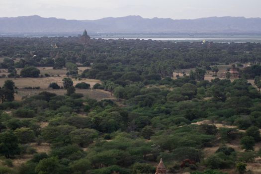 BAGAN, NYAUNG-U, MYANMAR - 3 JANUARY 2020: Looking out over the vast plains of Bagan with its historical temples and fields from the tall Nan Myint viewing tower