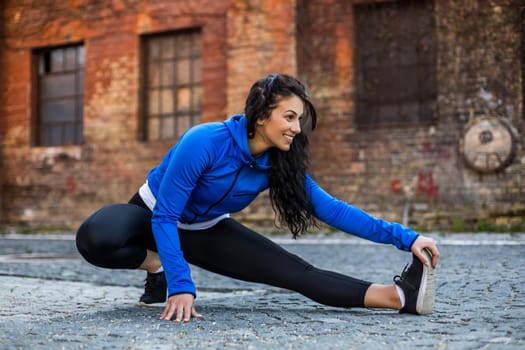 Beautiful woman enjoys  exercising outdoor.