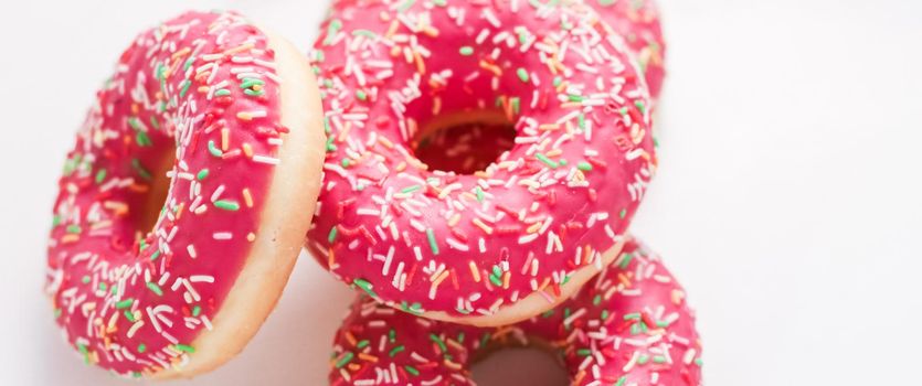 Bakery, branding and cafe concept - Frosted sprinkled donuts, sweet pastry dessert on marble table background, doughnuts as tasty snack, top view food brand flat lay for blog, menu or cookbook design