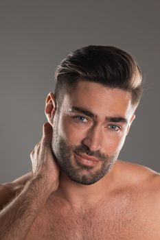 Closeup portrait of a beautiful male model, caucasian man with dark hair and gray eyes