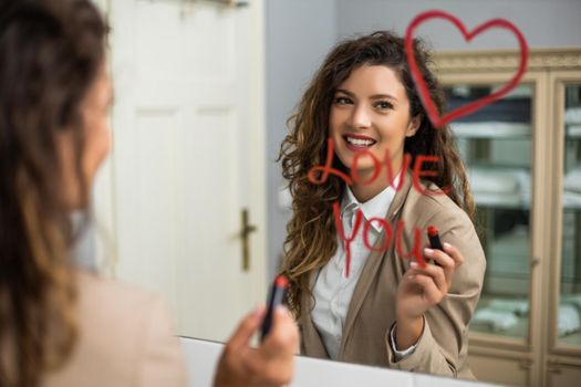 Businesswoman is drawing heart and  writing I love you with lipstick on the mirror while preparing for work.