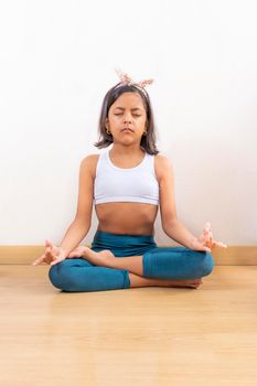 Teen girl doing yoga at home