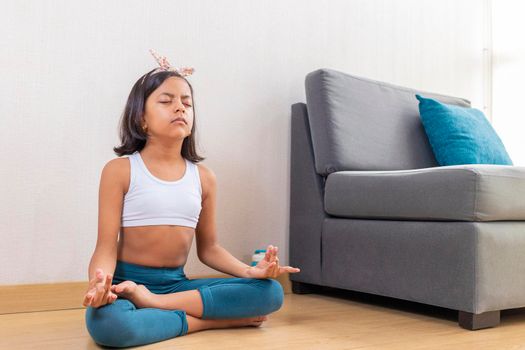 Teen girl doing yoga at home