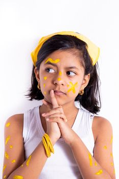 Happy little girl, with her face painted to celebrate the yellow day