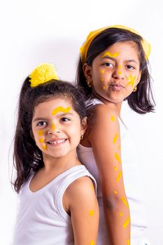 Two little girl, with her face painted to celebrate the yellow day