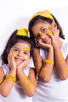 Two little girl, with her face painted to celebrate the yellow day