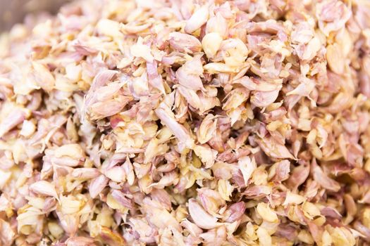 Crushed garlic with skin, minced or chopped vegetable background