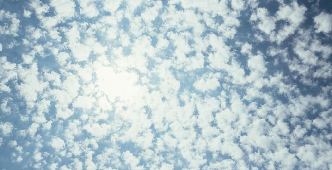 Small airy clouds on blue sky