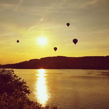 Beautiful colorful hot air balloon is flying at sunset. Brno Dam - Czech Republic.