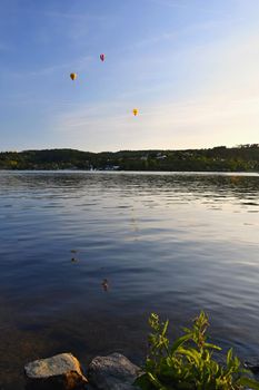 Beautiful colorful hot air balloon is flying at sunset. Brno Dam - Czech Republic.