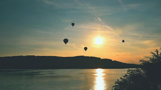 Beautiful colorful hot air balloon is flying at sunset. Brno Dam - Czech Republic.