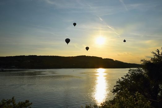 Beautiful colorful hot air balloon is flying at sunset. Brno Dam - Czech Republic.