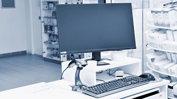 Cash desk - computer and monitor in a pharmacy. Interior of drug and vitamins shop. Concept for medicine and health - Coronavirus - COVID 19.
