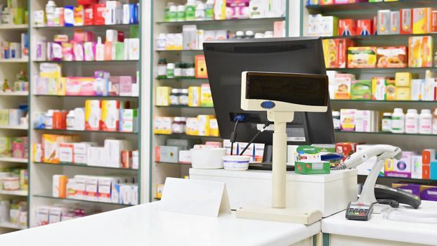 Cash desk - computer and monitor in a pharmacy. Interior of drug and vitamins shop. Concept for medicine and health - Coronavirus - COVID 19.
