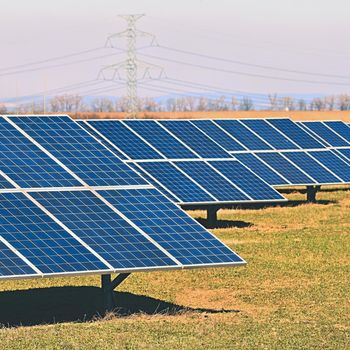 Solar panels in a field. Solar energy power plant. Industrial and ecological concept for nature and eco / green technology.