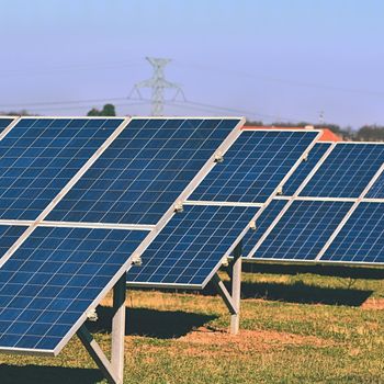 Solar panels in a field. Solar energy power plant. Industrial and ecological concept for nature and eco / green technology.