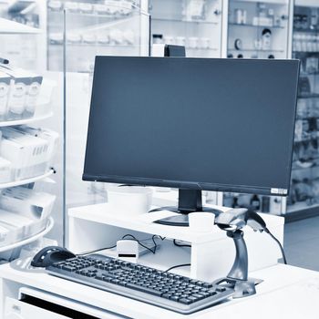 Cash desk - computer and monitor in a pharmacy. Interior of drug and vitamins shop. Medicines and vitamins for health and healthy lifestyle.  