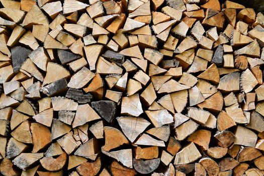 Firewood background. Chopped wood ready for winter