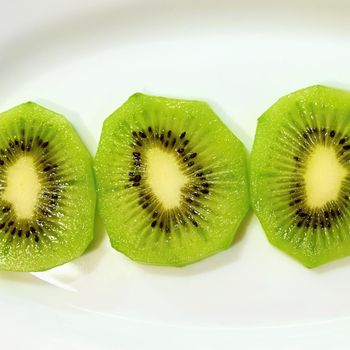 Kiwi on a plate. Close-up macro photo of healthy green tropical fruit