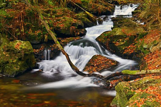 Beautiful colorful background with river and stones in autumn time. White Opava Waterfalls - Jeseniky Mountains - Czech Republic.