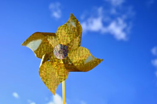 Beautiful yellow wind turbine - vane. Background with blue sky.