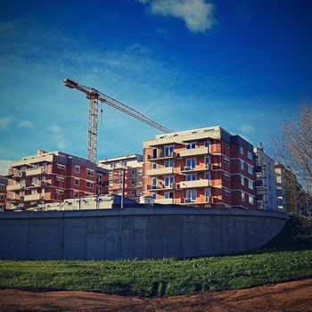 Crane and construction of new buildings. Beautiful background for the construction industry. 