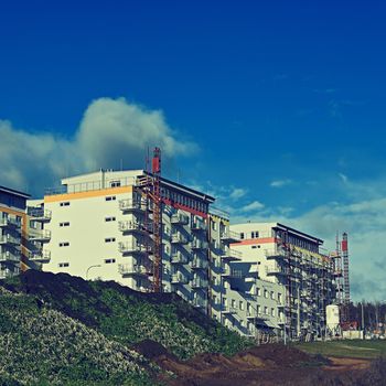 Crane and construction of new buildings. Beautiful background for the construction industry. 